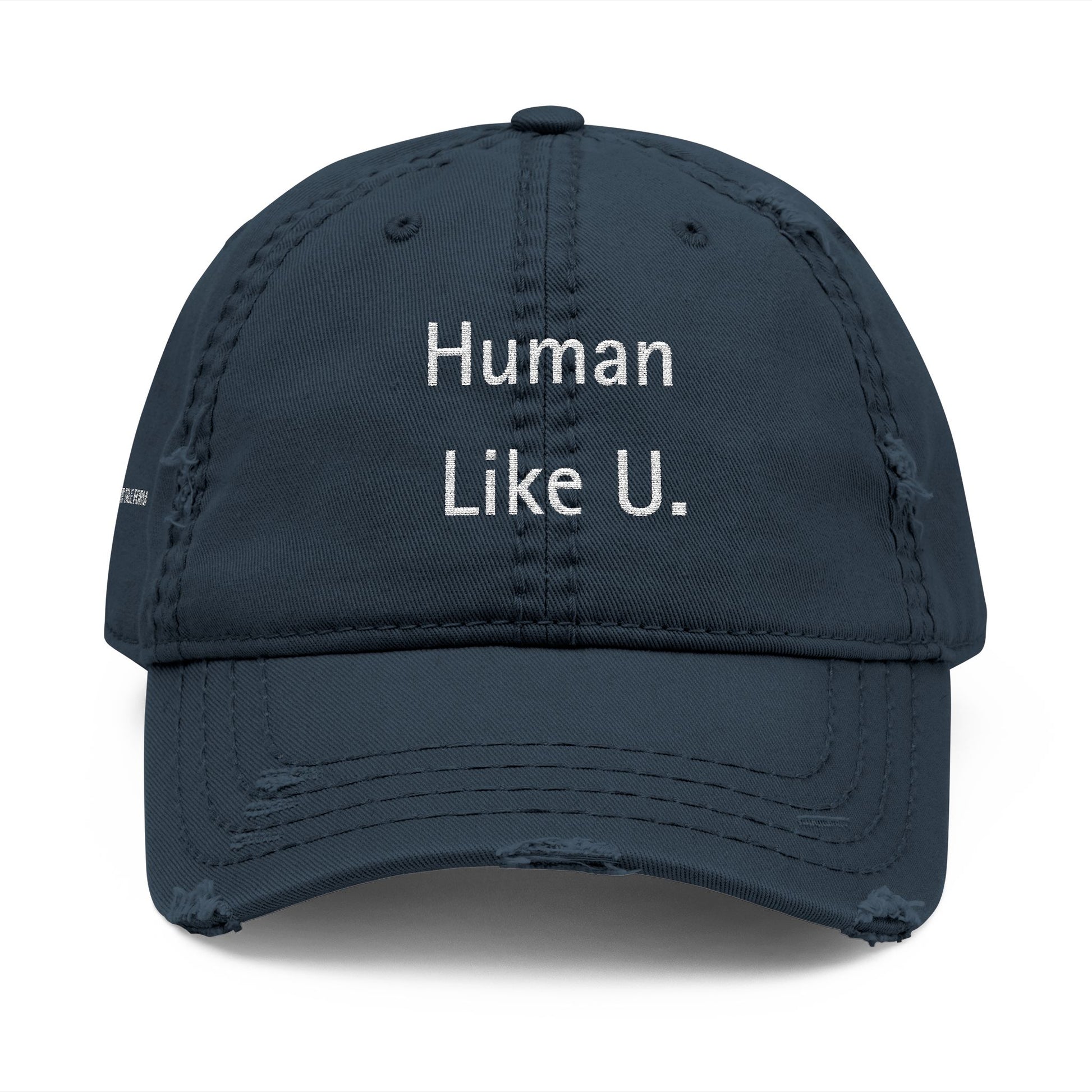 Close-up of a stylish cap with clear 'Human Like U.' text branding on a white background. This versatile headwear is an essential accessory for authentic lesbian style and confident lesbian fashion.