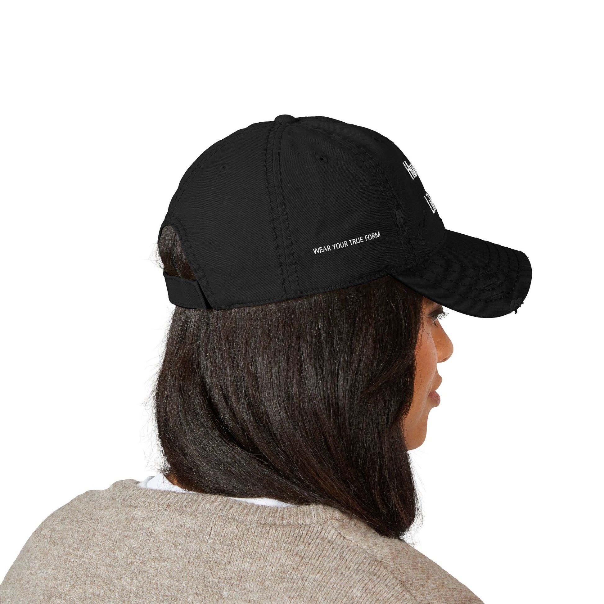 Person wearing a black cap with text on a white background