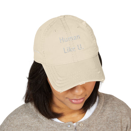Person wearing a stylish beige cap with 'Human Like U.' text branding against a white background. This neutral headwear is an essential accessory for defining authentic lesbian style and relaxed lesbian fashion.