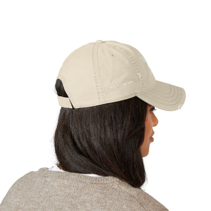 Person wearing a beige baseball cap on a white background