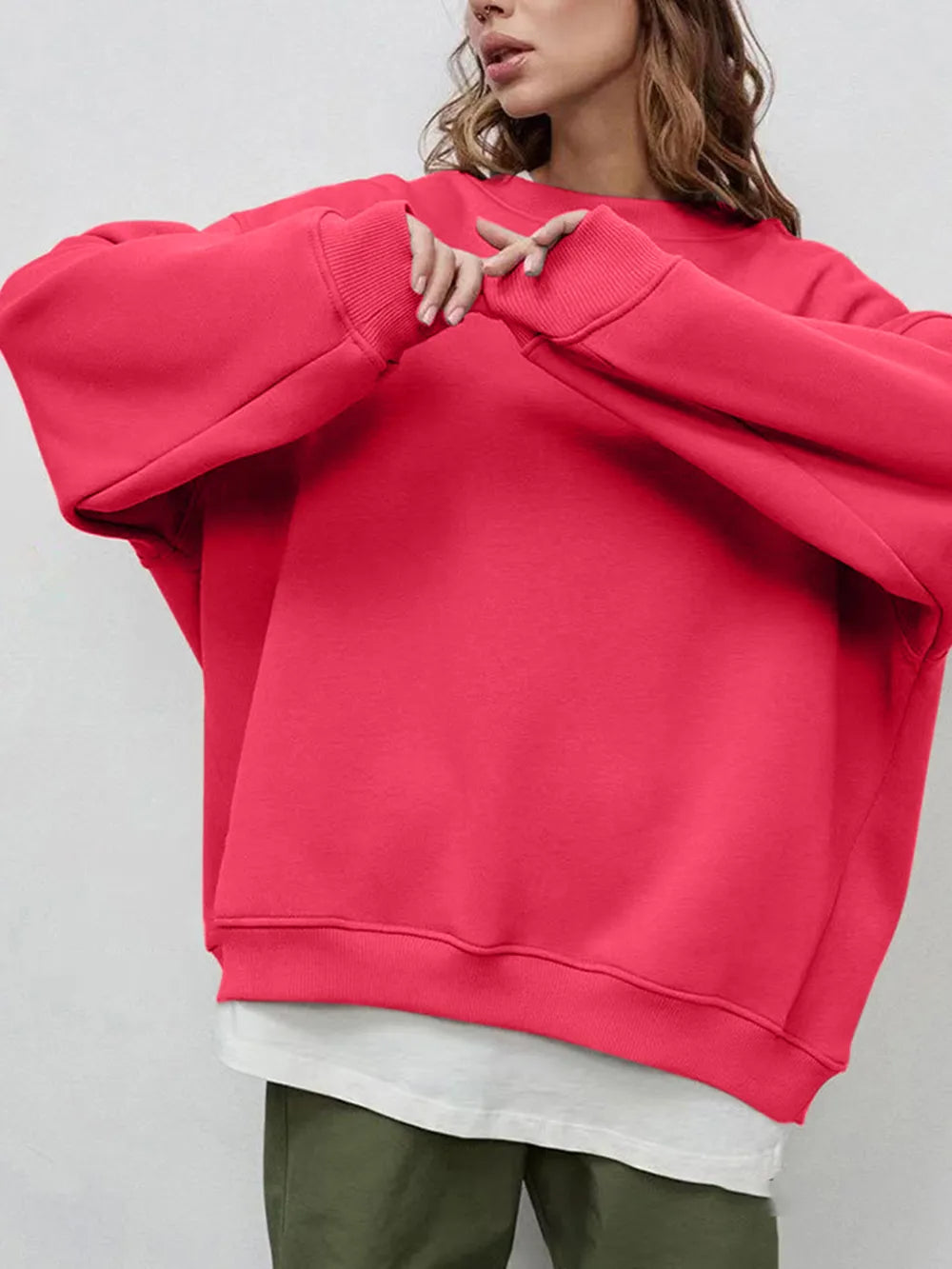 Person wearing a comfortable, bright pink oversized sweatshirt on a plain background. This bold lesbian outfit is a perfect example of casual lesbian clothing and vibrant lesbian style