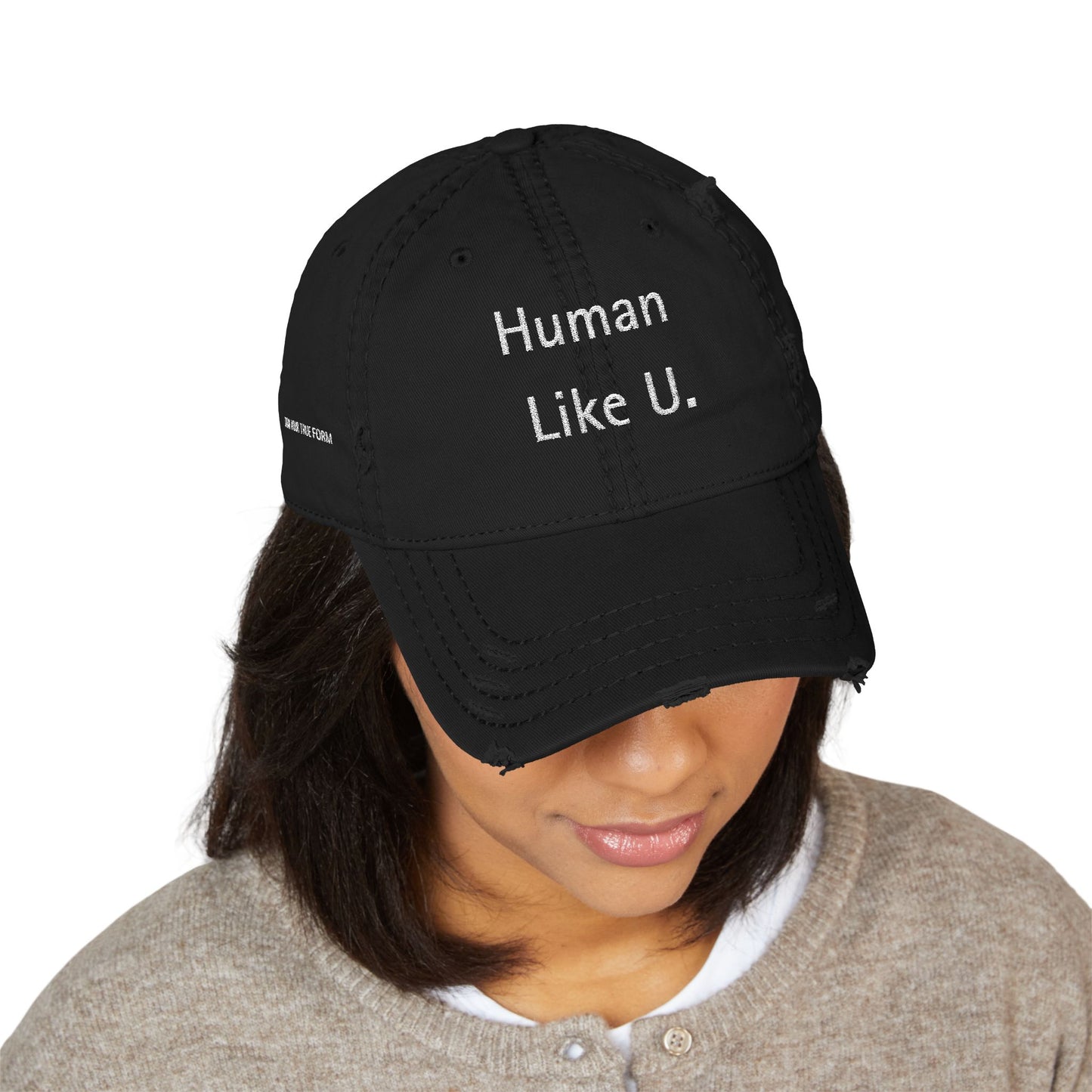 Person wearing a sharp black cap with 'Human Like U.' text branding against a white background. This confident headwear is an essential accessory for defining authentic lesbian style and relaxed lesbian fashion.