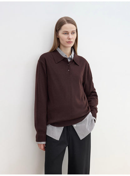 Person wearing a cozy brown sweater over a light shirt with sharp black pants against a white background. This classic lesbian outfit is a perfect example of confident lesbian fashion and authentic lesbian style.