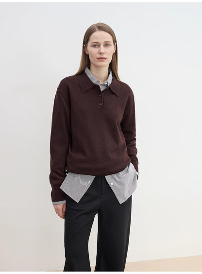 Person wearing a cozy brown sweater over a light shirt with sharp black pants against a white background. This classic lesbian outfit is a perfect example of confident lesbian fashion and authentic lesbian style.