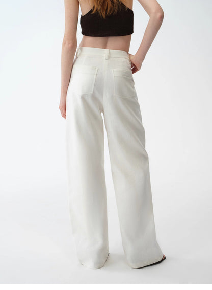 Person wearing white wide-leg pants and a black top on a white background. This casual lesbian outfit is a perfect example of confident lesbian fashion style and effortless lesbian style.