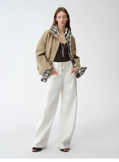 Person wearing a beige jacket, plaid shirt, brown top, white pants, and black shoes on a white background. This casual lesbian outfit is a perfect example of confident lesbian fashion style and effortless lesbian style.