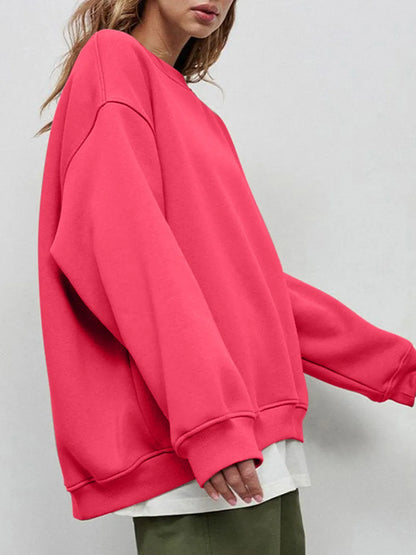 Person wearing a comfortable, bright pink oversized sweatshirt on a plain background. This bold lesbian outfit is a perfect example of casual lesbian clothing and vibrant lesbian style