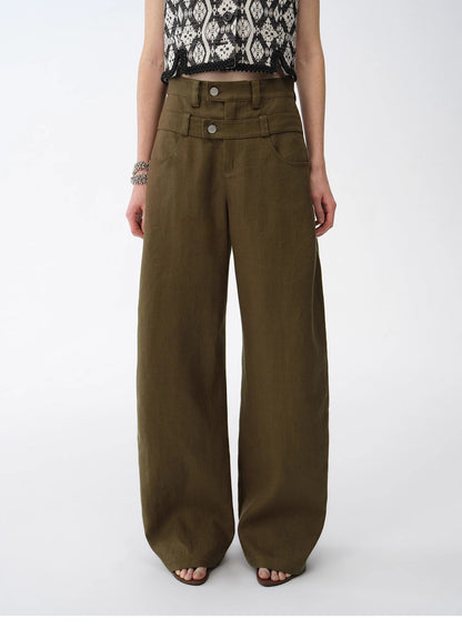 Person wearing olive green wide-leg pants on a white background. This casual lesbian outfit is a perfect example of confident lesbian fashion style and effortless lesbian style.