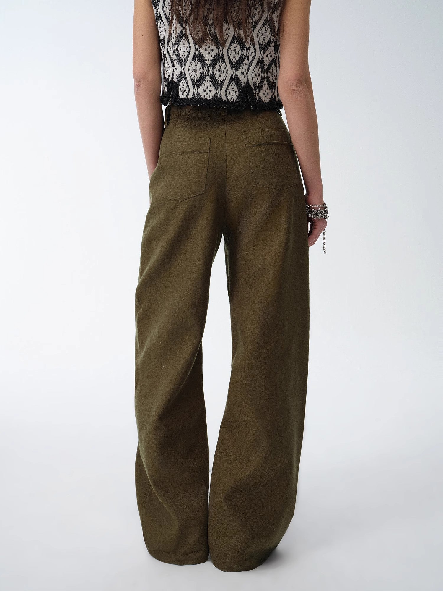 Person wearing olive green wide-leg pants on a white background. This casual lesbian outfit is a perfect example of confident lesbian fashion style and effortless lesbian style.