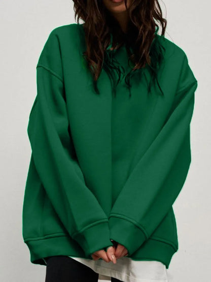Person wearing a comfortable green sweatshirt on a plain background. This classic lesbian outfit is a perfect example of casual lesbian clothing and relaxed lesbian style.