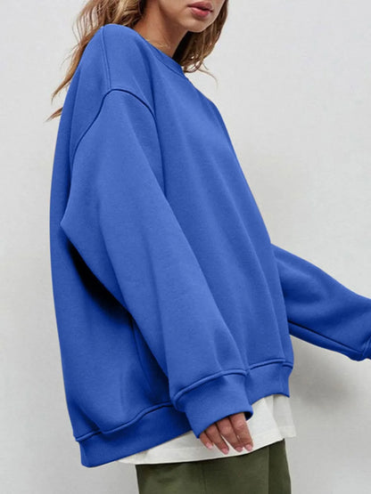 Person wearing a comfortable blue oversized sweatshirt on a light gray background. This classic lesbian outfit is a perfect example of casual lesbian clothing and relaxed lesbian style.