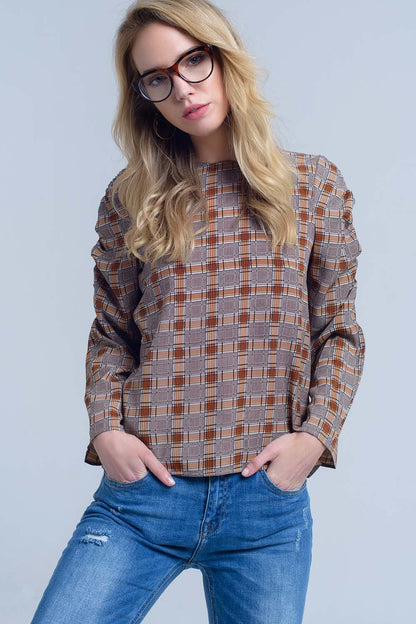 Woman wearing a classic plaid shirt and jeans against a plain background. This iconic lesbian outfit is a perfect example of casual lesbian fashion and authentic lesbian style.