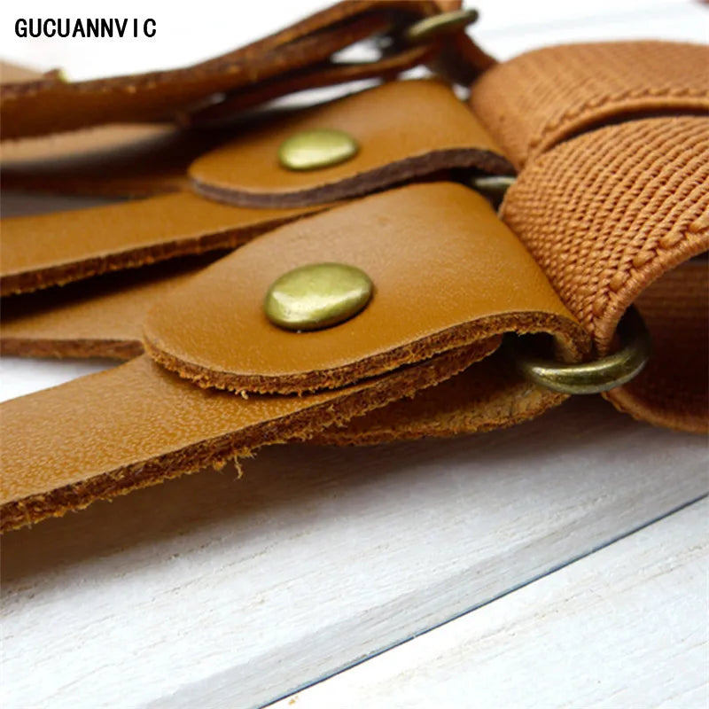 Close-up of a brown leather strap with brass buttons and 'GUCUANNY' branding on a white surface. These high-quality accessories are essential for building a sharp lesbian outfit and defining an authentic lesbian style.