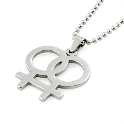 Silver necklace featuring a double gender symbol pendant on a dark surface. A key piece of lesbian fashion to define your lesbian style. Essential lesbian attire accessory for a confident lesbian outfit.