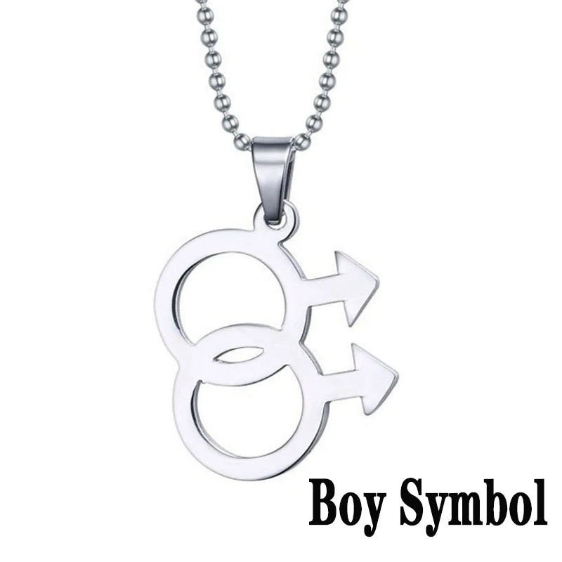 Silver necklace featuring a double gender symbol pendant on a dark surface. A key piece of lesbian fashion to define your lesbian style. Essential lesbian attire accessory for a confident lesbian outfit.