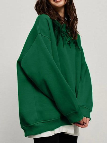 Person wearing a comfortable green sweatshirt on a plain background. This classic lesbian outfit is a perfect example of casual lesbian clothing and relaxed lesbian style.