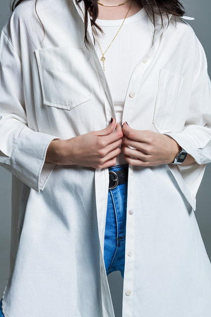 Person wearing a white lab coat layered over a white shirt and blue jeans with a neutral background. This sharp, confident lesbian outfit is a perfect example of tailored lesbian fashion and authentic lesbian style.