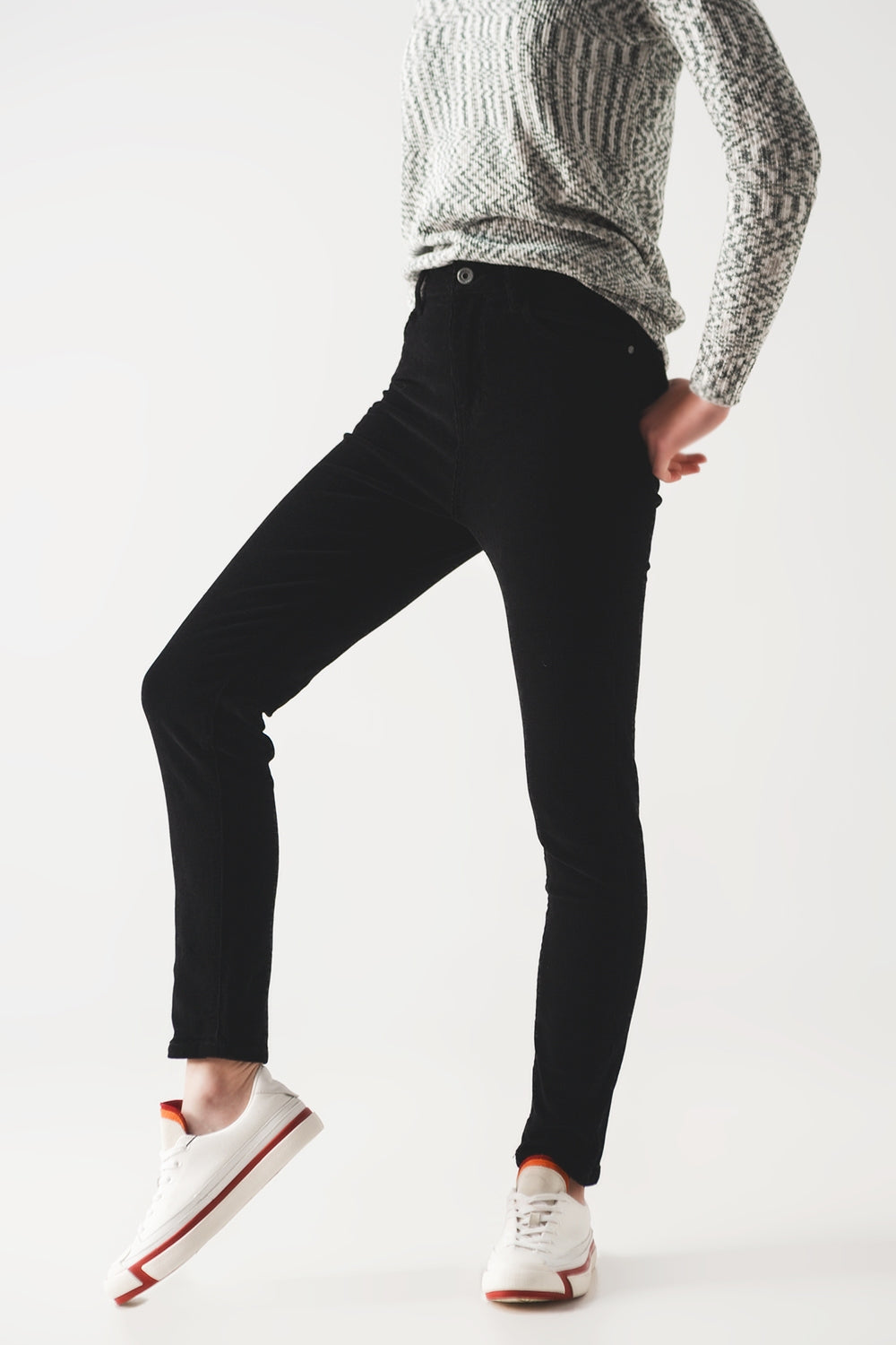 Person wearing sharp black pants and a cozy gray sweater against a white background. This classic lesbian outfit is a perfect example of confident lesbian fashion and authentic lesbian style.