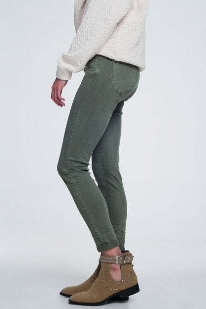 Person modeling green jeans and brown boots on a white background. This sharp, casual lesbian outfit is a perfect example of confident lesbian fashion and authentic lesbian style.